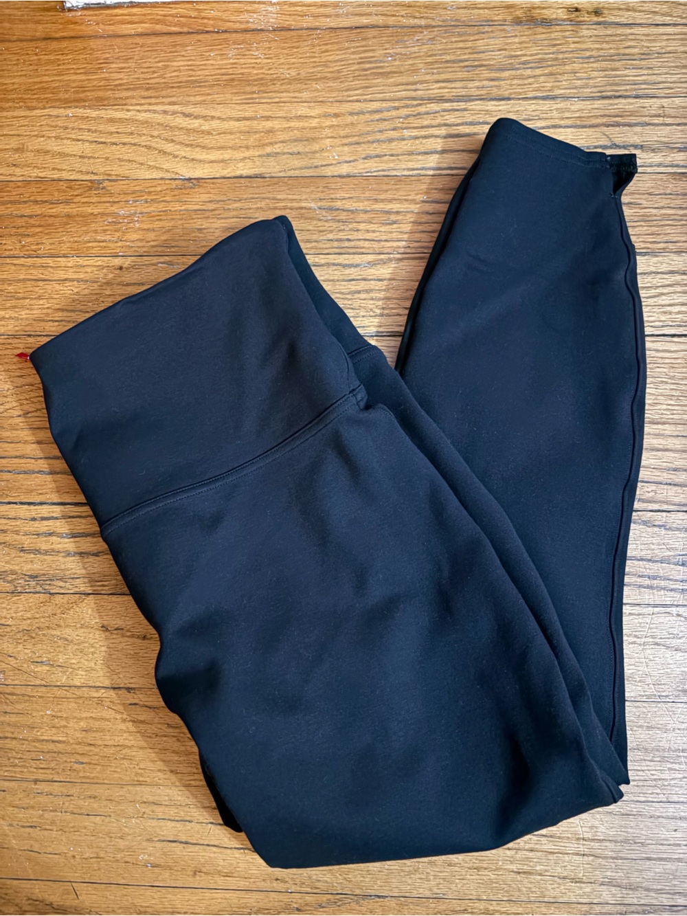 SPANX Black tapered pant/legging with small “V” slit on bottom of legs
